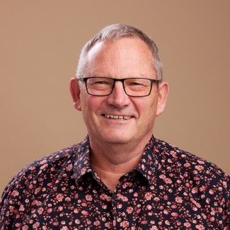 Photo of a smiling James Renwick taken in February 2023.